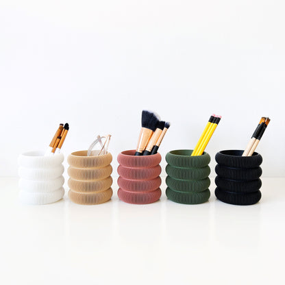 Five pen holders with ribbed bubble design in different colros